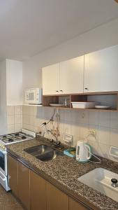 a kitchen with a sink and a counter top at SIERRAS TRAVEL 2f in Villa Carlos Paz