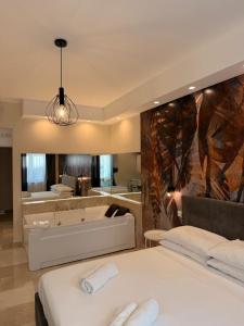 a bedroom with two beds and a bath tub at Suite 55 in centro in Trani +30 photos