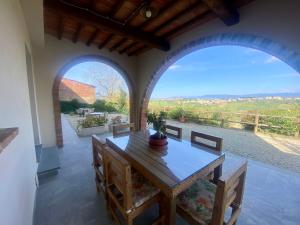 a dining room with a table and two large windows at Agriturismo Villa Adimari in Cerreto Guidi