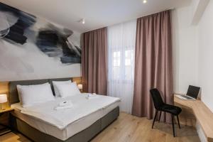 a hotel room with a bed and a chair at Bacan Serviced Apartments in Cavtat