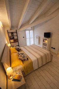 a bedroom with a large bed and a television at Mansarda Polpetta in Corsico