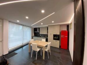 a kitchen with a table and a red refrigerator at Risorgimento House in Isernia