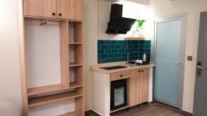 a small kitchen with a sink and a stove at Central Park Hotel İstanbul in Istanbul