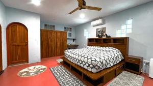 a bedroom with a bed and a ceiling fan at Kaan Serenity Sanctuary in Coba +21 photos