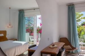 a bedroom with a bed and a large window at Hotel Fortuna in Los Caños de Meca +54 photos
