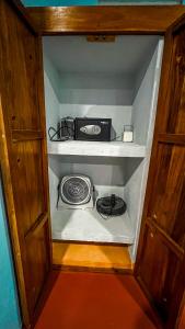 a small cabinet with a stove and a microwave at Kaan Serenity Sanctuary in Coba
