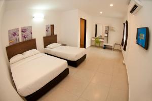Postel nebo postele na pokoji v ubytování Hotel Cheqinn