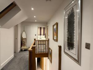 a hallway with a staircase in a house at Broadway Pool House with Sauna & Jacuzzi in Herne Bay +58 photos
