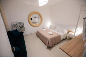 a bedroom with a bed with a mirror on the wall at Salento IBIZA in Gallipoli +20 photos