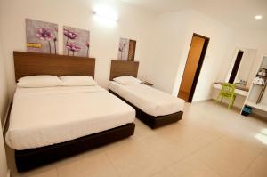 Postel nebo postele na pokoji v ubytování Hotel Cheqinn