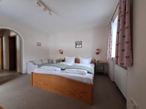 a bedroom with a large bed in a room at Zoberhof - Ferienhof zum Zoberbauer in Oberammergau