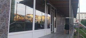 a reflection of buildings in the windows of a building at "Augustina" apartment in Topliţa