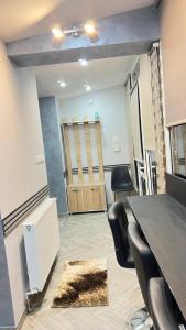 a room with a table and chairs and a door at "Augustina" apartment in Topliţa