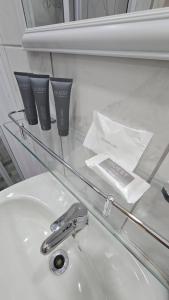 a glass counter top with a sink and a faucet at Waverley Rest in Bloemfontein +46 photos