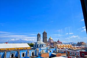 a view of a city with buildings and mosques at Hotel Tamara in Puebla