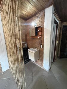 a bathroom with a sink and a brick wall at Flats na praia de Trindade Paraty flats nazar in Paraty