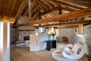 a kitchen with a refrigerator in a room with wooden ceilings at Le Torri di Credazzo in Farra di Soligo