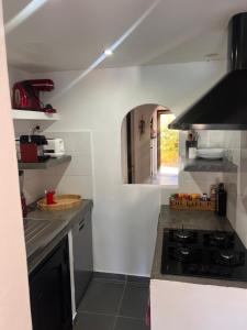 a kitchen with a stove and a counter top at villa rêve in Calvi