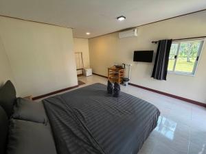 a bedroom with a bed and a flat screen tv at NgopaKohKoodResort in Ban Bang Bao