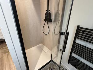 a shower with a glass door in a bathroom at Petite Merveille sous les toits - Centre de Dijon in Dijon
