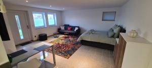 a living room with a bed and a couch at All Senses Ferienwohnung in Hirschbach