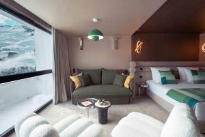 a hotel room with a bed and a couch at Fahrenheit Seven Les Menuires in Les Menuires +17 photos