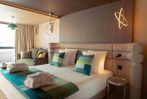 a bedroom with a large bed with two bags on it at Fahrenheit Seven Les Menuires in Les Menuires