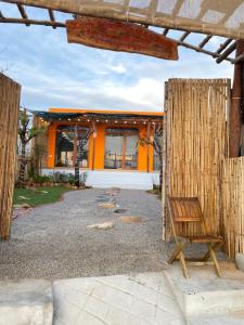 a wooden bench sitting in front of a building at Xóm Chài Homestay in Thôn Sơn Hải