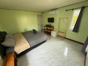 a bedroom with a bed and a television in it at NgopaKohKoodResort in Ban Bang Bao