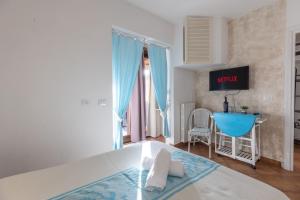 a bedroom with a bed and a table in a room at Ventimiglia Garden Suite in Olbia +5 photos