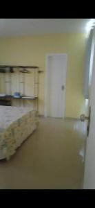 an empty room with a white door and a floor at Aconchego perto da praia in Aracaju +8 photos