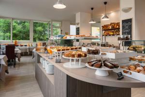 a bakery with many different types of pastries on display at Hotel Alexander in Riccione