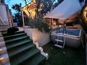 a set of stairs leading to a swimming pool at night at Aqua B7 in Cavo