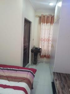 a room with a bed and a table and a window at Haven Breeze Villas in Nakuru
