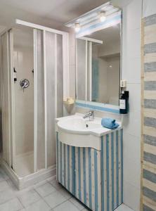 a bathroom with a sink and a shower at Aqua B7 in Cavo +8 photos