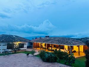 a house with a cat on the roof at night at Hacienda Campestre Oasis de la Villa in Villa de Leyva