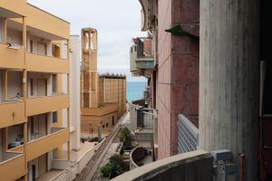 an alley between buildings with the ocean in the background at Salento IBIZA in Gallipoli