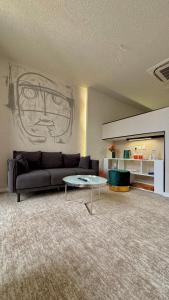 a living room with a couch and a table at هدوء المنتهى in Al Munayzilah