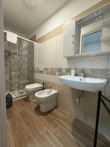 a bathroom with a sink and a toilet at La Rosa dei Venti in SantʼAntìoco +18 photos