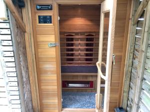 a door leading into a wine cellar in a sauna at Cosy hideaway with garden sauna in Cambridge in Cambridge
