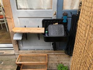 a front door of a house with a trash can at Cosy hideaway with garden sauna in Cambridge in Cambridge +14 photos