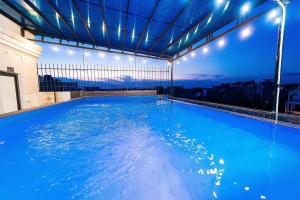 a large blue swimming pool on top of a building at Khách Sạn Melanta - FLC Sầm Sơn in Sầm Sơn