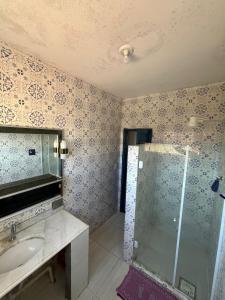 a bathroom with a shower and a sink at Santorini Flats in Arraial do Cabo
