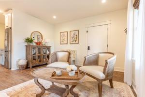 a living room with two chairs and a table at Kildahl House - Boutique Farmhouse Suite #1 in West Dundee
