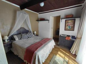 a bedroom with a bed with a canopy at Uncle Charlie in Kroonstad