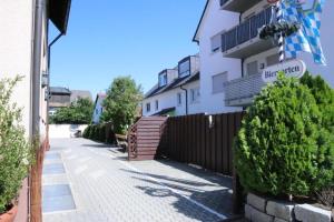 a building with a fence and a street sign at Budget Messehotel by Daucher in Nuremberg