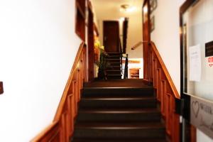 a stairway in a building with wooden stairs at Budget Messehotel by Daucher in Nuremberg