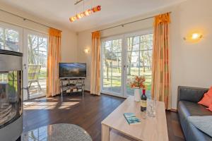 a living room with a couch and a tv at Ferienhaus "Ferien am Haff" in Zirchow