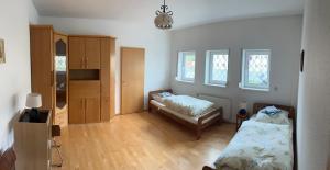 a room with a bedroom with a bed and a cabinet at Ferienwohnung Hainspitz Longstay in Hainspitz