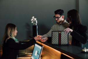 a group of three people shaking hands at a desk at Hotel PALAZZO PEPE & JACUZZI in Naples